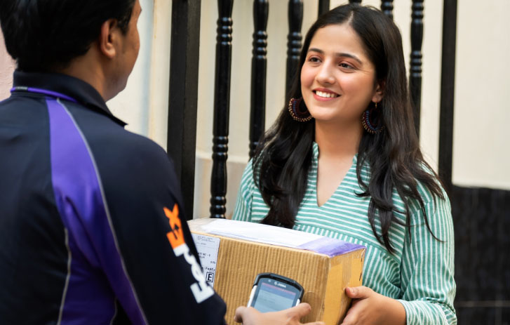 Courier handing a package to a customer at the door